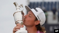 Cameron Smith of Australia kisses the claret jug trophy as he poses for photographers on the 18th green after winning the British Open golf championship on the Old Course at St. Andrews, Scotland, July 17, 2022.