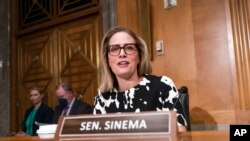 Sen. Kyrsten Sinema arrives for a meeting of the Senate Homeland Security Committee at the Capitol in Washington, Aug. 3, 2022. 