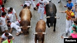 Revelers sprint during the running of the bulls at the San Fermin festival in Pamplona, Spain, July 14, 2022.