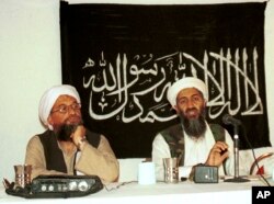 In this 1998 file photo made available Friday, March 19, 2004, Ayman al-Zawahri, left, listens during a news conference with Osama bin Laden in Khost, Afghanistan. (AP Photo/Mazhar Ali Khan, File)