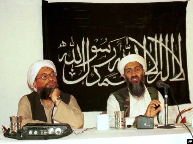 In this 1998 file photo made available Friday, March 19, 2004, Ayman al-Zawahri, left, listens during a news conference with Osama bin Laden in Khost, Afghanistan. (AP Photo/Mazhar Ali Khan, File)