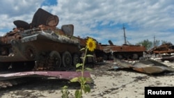 Destroyed Russian military vehicles at a compound of an agricultural farm, which was used by Russian troops as a military base during Russia's attack on Ukraine, in Kharkiv Region, Ukraine, July 17, 2022. 