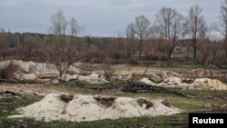 FILE - Trenches dug by the Russian military are seen in an area with high levels of radiation called the Red Forest, near the Chernobyl Nuclear Power Plant, in Chernobyl, Ukraine, April 16, 2022.