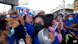 Mujeres golpearon cacerolas mientras miembros del sindicato de maestros en huelga protestan durante una marcha hacia la Asamblea Nacional en Ciudad de Panamá, el lunes 11 de julio de 2022.