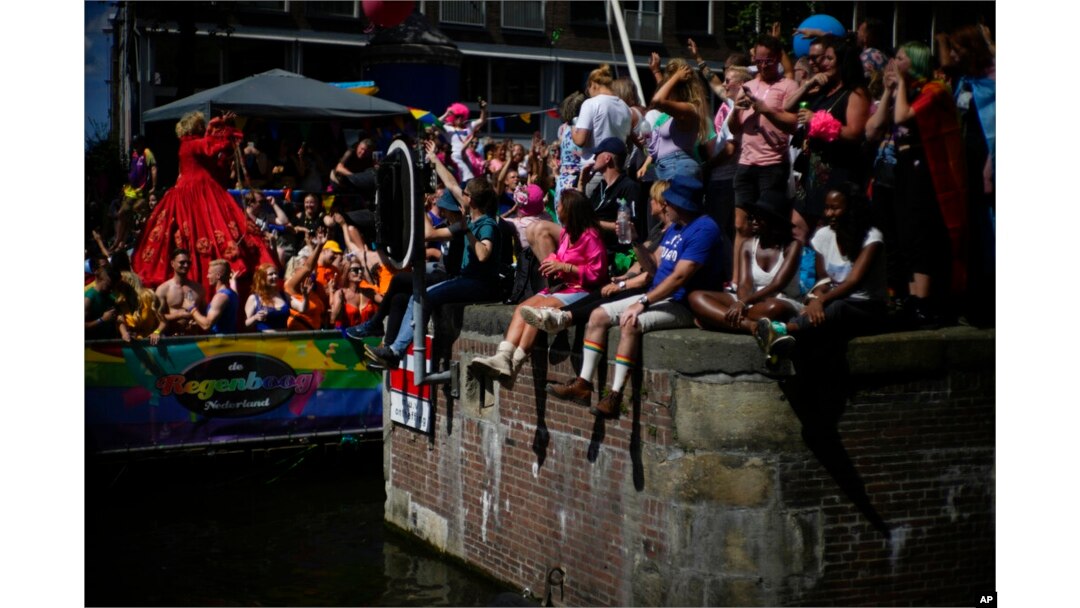 Hundreds of thousands of people lined canals in the Dutch capital to watch the Canal Parade, in Amsterdam, Netherlands, Aug. 6, 2022.