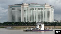 A ferry service transports passengers and vehicles along the Mekong River in front of the Sokha hotel that will host the 55th ASEAN Foreign Ministers' Meeting in Phnom Penh, Cambodia, Aug. 1, 2022.