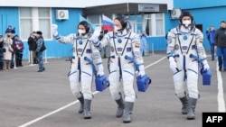 FILE - Russian cosmonauts headed for the International Space Station get ready to board the Soyuz MS-21 spacecraft prior to its launch at the Russia-leased Baikonur cosmodrome in Kazakhstan, March 18, 2022. (Russian Space Agency Roscosmos handout via AFP) 