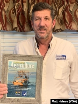 Rodney Olander, a Louisiana shrimper and member of the Louisiana Shrimp Task Force, with a photo of his shrimping boat featured on the cover of Louisiana Agriculture magazine.