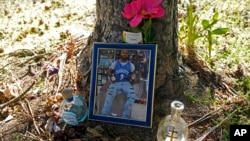 A memorial for Christopher Roberts Jr., who was killed in a 2020 shooting in the parking lot of a Safeway store in Seattle's Rainier Beach neighborhood, is shown Tuesday, July 12, 2022 