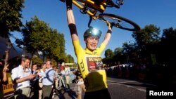 FILE: Jonas Vingegaard, from Denmark, wearing the overall leader's yellow jersey, celebrates winning the Tour de France, in Paris, July 24, 2022. 