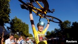 Jonas Vingegaard, from Denmark, wearing the overall leader's yellow jersey, celebrates winning the Tour de France, in Paris, July 24, 2022. 