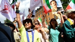 People react to the verdict of the trial of Hamid Noury, a former Iranian prosecution official accused of crimes against international law and murder in Iran in 1988, outside the Stockholm District Court in Sweden, July 14, 2022. Noury was sentenced to life in prison.