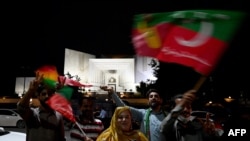 Supporters of former Pakistan's Prime Minister Imran Khan celebrate in Islamabad on July 26, 2022, after the Supreme Court declared that Khan's candidate should be the next Chief Minister of Punjab province.