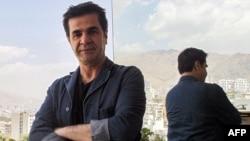 FILE - In this file photo taken on Aug. 30, 2010, Iranian film director Jafar Panahi stands on a balcony overlooking Tehran during an interview with Agence France-Presse.