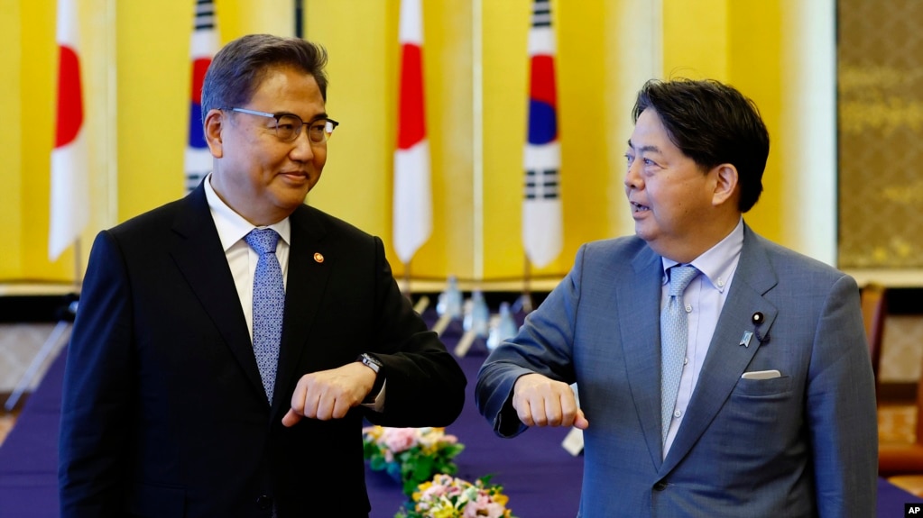 FILE - South Korean Foreign Minister Park Jin, left, and Japanese counterpart Yoshimasa Hayashi bump elbows before their talk in Tokyo, July 18, 2022. 