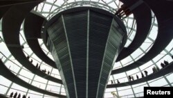 FILE - People walk on a gangway inside the new dome of the once and future home of the German parliament, the Reichtag, March 6, 1998.