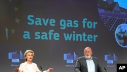 European Commission President Ursula von der Leyen, left, and European Commissioner for European Green Deal Frans Timmermans address a media conference at EU headquarters in Brussels, July 20, 2022. 