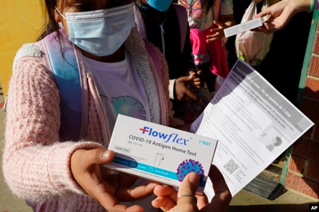 A second grade student is given a at-home COVID-19 test at H.W. Harkness Elementary School in Sacramento, Calif., on Feb. 11, 2022. (AP Photo/Rich Pedroncelli, File)