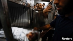 The body of a Palestinian girl is seen at a hospital after she was killed during Israeli strikes in Gaza City, August 5, 2022.