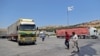 FILE - A convoy transporting humanitarian aid crosses into Syria from Turkey through the Bab al-Hawa border crossing on July 8, 2022. 