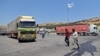 FILE - A convoy transporting humanitarian aid crosses into Syria from Turkey through the Bab al-Hawa border crossing on July 8, 2022. 