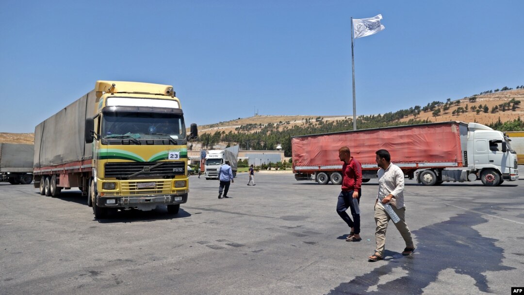 FILE - A convoy transporting humanitarian aid crosses into Syria from Turkey through the Bab al-Hawa border crossing on July 8, 2022. 