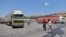 FILE - A convoy transporting humanitarian aid crosses into Syria from Turkey through the Bab al-Hawa border crossing on July 8, 2022. 