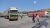 FILE - A convoy transporting humanitarian aid crosses into Syria from Turkey through the Bab al-Hawa border crossing on July 8, 2022. 