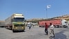 FILE - A convoy transporting humanitarian aid crosses into Syria from Turkey through the Bab al-Hawa border crossing on July 8, 2022. 