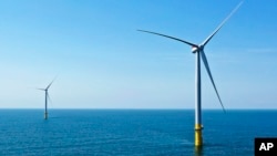 FILE - Two of the offshore wind turbines that have been constructed off the coast of Virginia Beach, Virginia, are seen on June 29, 2020. Part of President Joe Biden's plans for climate change include more development of the wind industry.