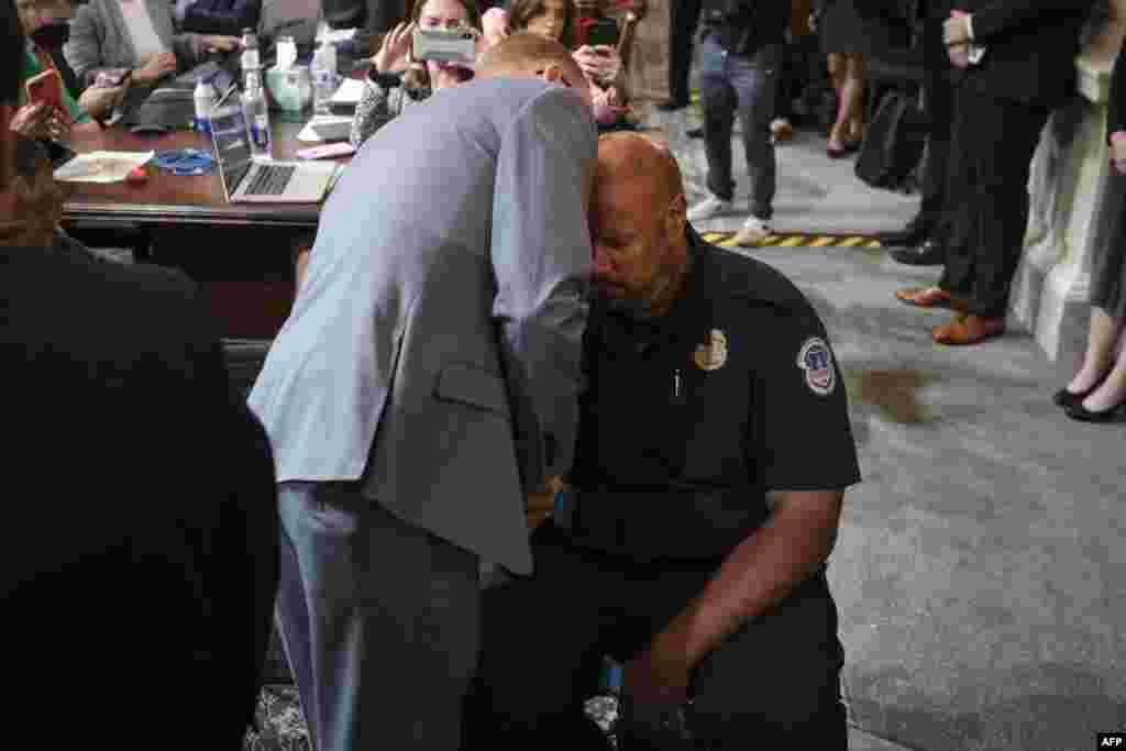 Stephen Ayres (L), who has pleaded guilty to entering the Capitol illegally on January 6, talks to U.S. Capitol Police Officer Harry Dunn (R) at the conclusion of a full committee hearing on &quot;the January 6th Investigation,&quot; on Capitol Hill, July 12, 2022, in Washington, D.C.