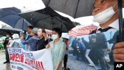 Members of North Korean human rights stage a rally to denounce South Korea's deportation of two North Korean fishermen in 2019, in front of the National Assembly in Seoul, South Korea, July 13, 2022.