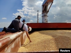 The Joint Coordination Centre officials are seen onboard Sierra Leone-flagged cargo ship Razoni, carrying Ukrainian grain, during an inspection in the Black Sea off Kilyos, near Istanbul, Aug. 3, 2022.