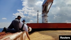 Joint Coordination Center officials are seen aboard the Sierra Leone-flagged cargo ship Razoni, carrying Ukrainian grain, during an inspection in the Black Sea off Kilyos, near Istanbul, Aug. 3, 2022.