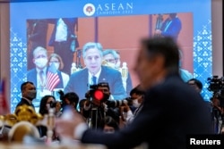Members of the media watch as U.S. Secretary of State Antony Blinken speaks during a U.S. ministerial meeting at the Sokha Hotel in Phnom Penh, Cambodia, Aug. 4, 2022.