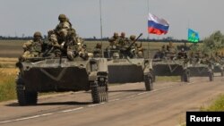 An armored convoy of Russian troops drives in Russian-held part of Zaporizhzhia region, Ukraine, July 23, 2022. 