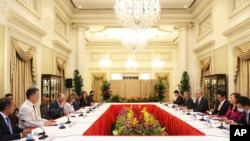 In this photo provided by Ministry of Communications and Information, Singapore, U.S. House Speaker Nancy Pelosi, fourth from left, and Prime Minister Lee Hsien Loong, fourth from right, meet at the Istana Presidential Palace in Singapore, Aug. 1, 2022. 