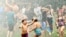 Water rains down on children during the Geneva Water Battle, July 24, 2022, at Memorial Field in Geneva, Ohio. Firetrucks provided relief for hundreds during the event, held on a day when more than 85 million Americans were under excessive heat warnings or advisories.