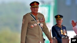 FILE - Pakistan's Army Chief General Qamar Javed Bajwa arrives at a military parade to mark Pakistan National Day in Islamabad, Pakistan, March 23, 2022. 