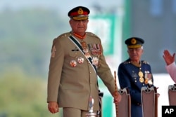 FILE - Pakistan's Army Chief General Qamar Javed Bajwa arrives to attend a military parade to mark Pakistan National Day in Islamabad, March 23, 2022.