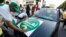 A man distributes stickers urging Tunisians to vote "yes" in a referendum for a new constitution, in Habib Bourguiba Avenue in downtown Tunis, Tunisia, July 23, 2022. 