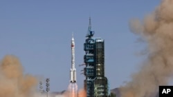 In this photo released by Xinhua News Agency, the Long March-2F carrier rocket carrying China's Shenzhou 14 spacecraft blasts off from the launch pad at the Jiuquan Satellite Launch Center in Jiuquan, in northwest China's Gansu province, June 5, 2022.