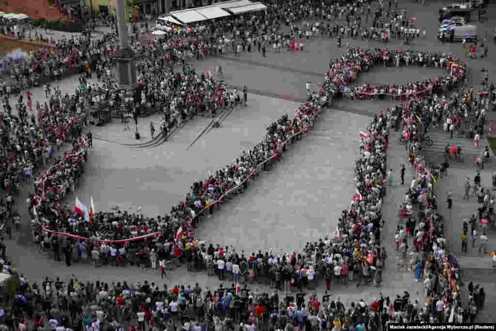 People take part in a commemoration to mark the 78th anniversary of the Warsaw Uprising against Nazi occupation during World War II, in Warsaw, Poland.