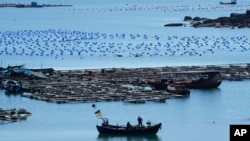 A boat moves through the water at the 68-nautical-mile scenic spot, the closest point in mainland China to the island of Taiwan, in Pingtan in southeastern China's Fujian province, Aug. 5, 2022.