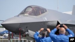 FILE: Visitors take pictures of a F35 Lightning 2 fighter plane at the Farnborough Air Show fair in Farnborough, England, July 18, 2022. 