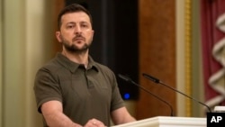 FILE - Ukrainian President Volodymyr Zelenskyy stands at the podium during a news conference in Kyiv, Ukraine, July 3, 2022.