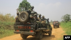 FILE: Vehicles of FARDC (Armed Forces of the Democratic Republic of Congo) soldiers escort civilian vehicles transporting goods on the Beni-Komanda road. Taken 3.19.2022