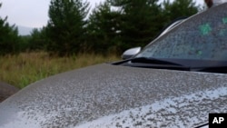 Ash from Sakurajima volcano is seen on a vehicle in Kagoshima, southern island of Kyushu, Japan Monday, July 25, 2022. The volcano erupted Sunday night, spewing ash and rocks, causing dozens of residents in nearby towns to evacuate to a safer part of the region.