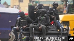 Police officers patrol during a protest by Nigeria Labour Congress on the street in Lagos, Nigeria, Tuesday, July 26, 2022. More police have been deployed to the capital of Abuja after attacks last week on presidential guards and at a military checkpoint.