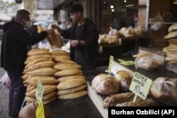 FILE - A man buys bread in Ulus area of the capital Ankara, Turkey, on May 5, 2022. (AP Photo/Burhan Ozbilici, File)